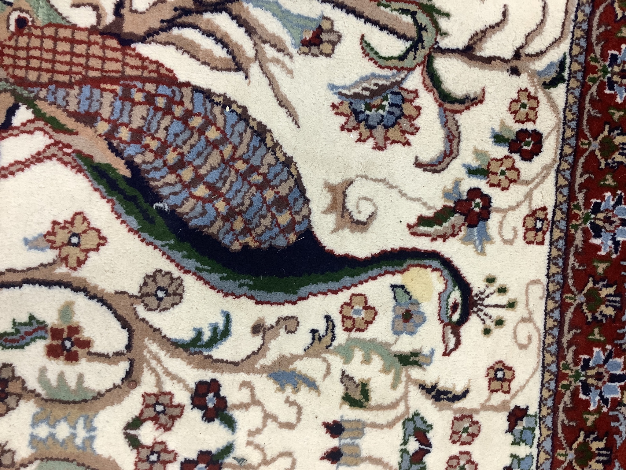 A Tabriz ivory ground 'Peacock' rug, 122 x 120cm